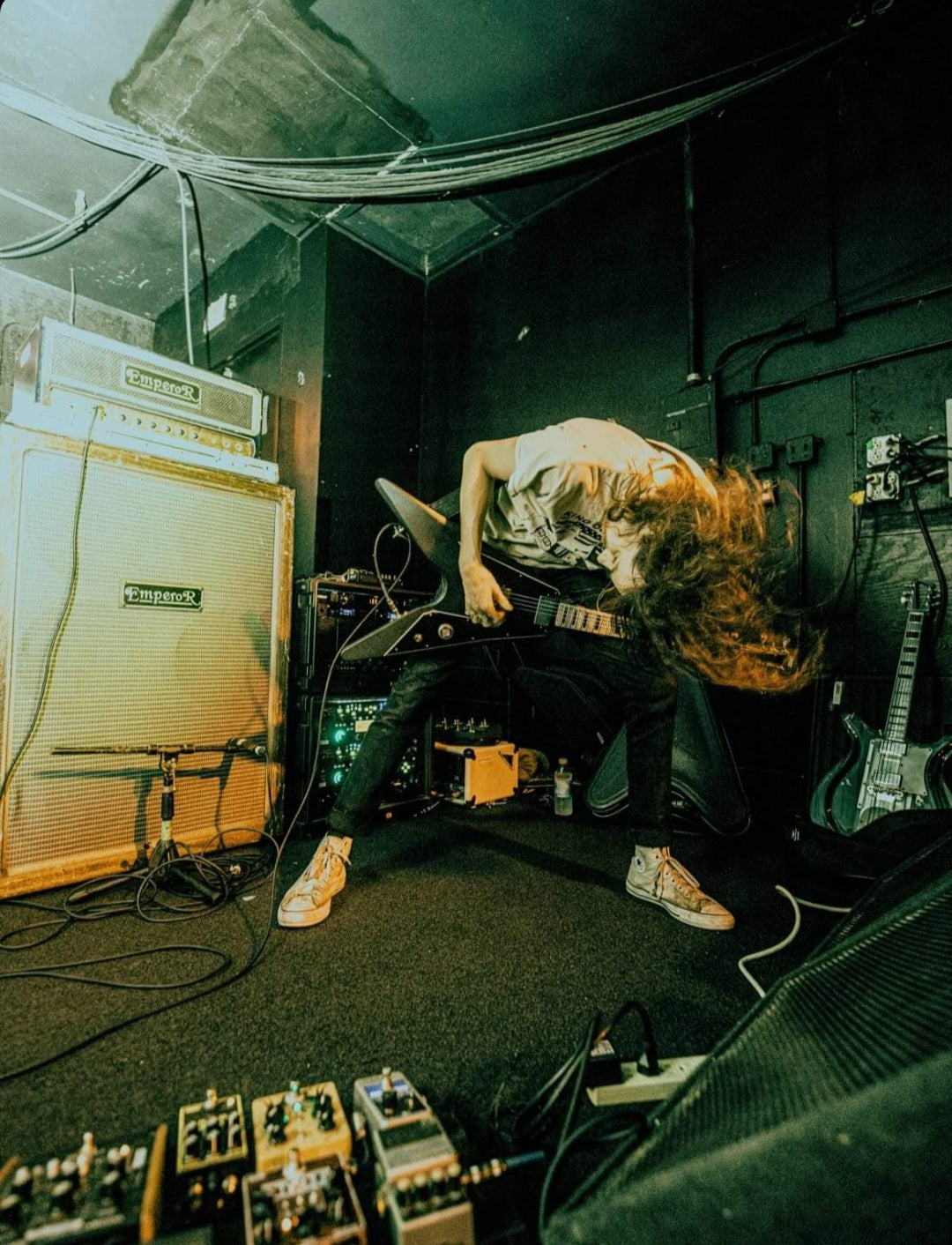 Headbanging while playing guitar