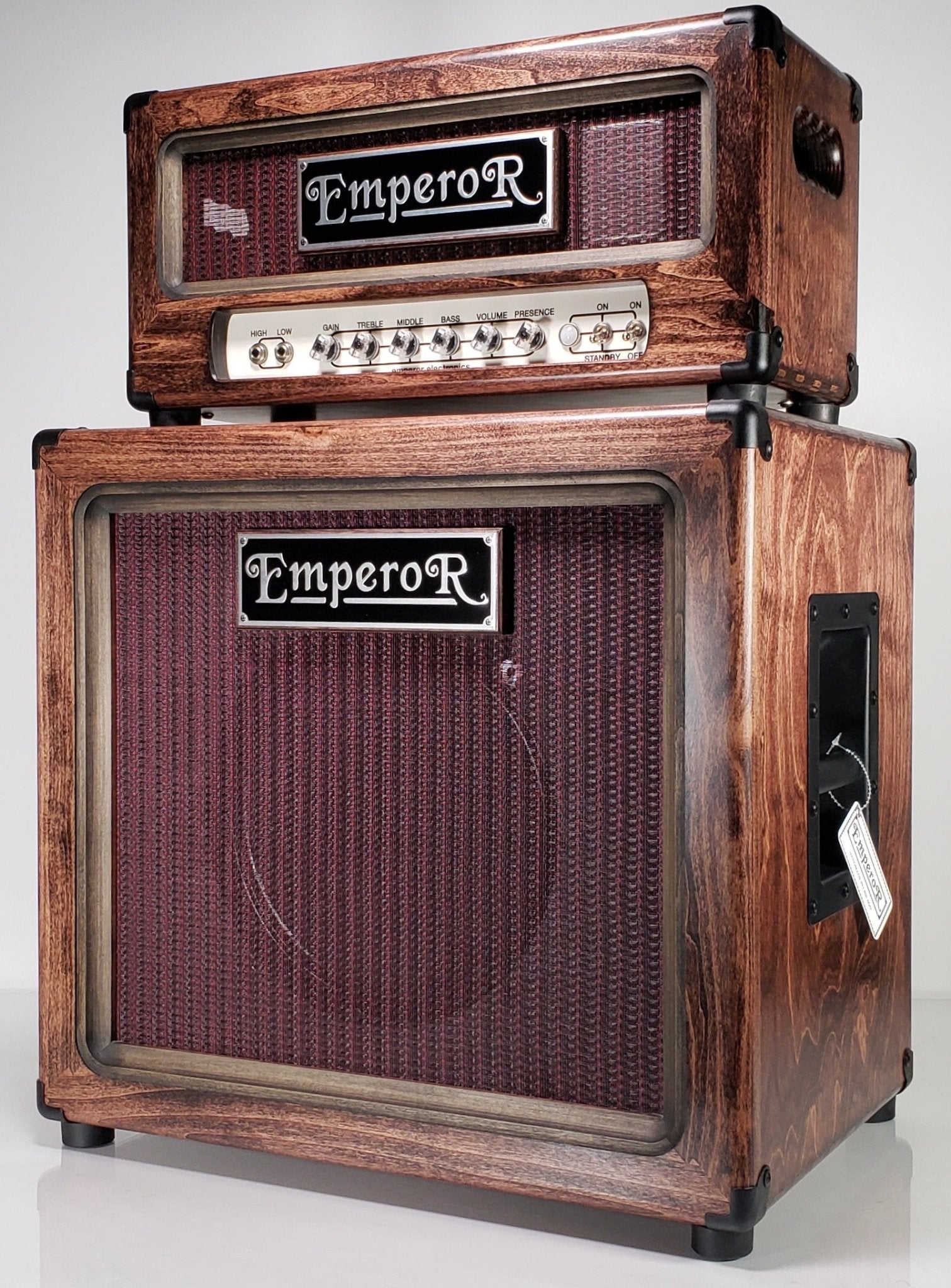 a 100 watt guitar amplifier on top of a 1x12 guitar speaker cabinet