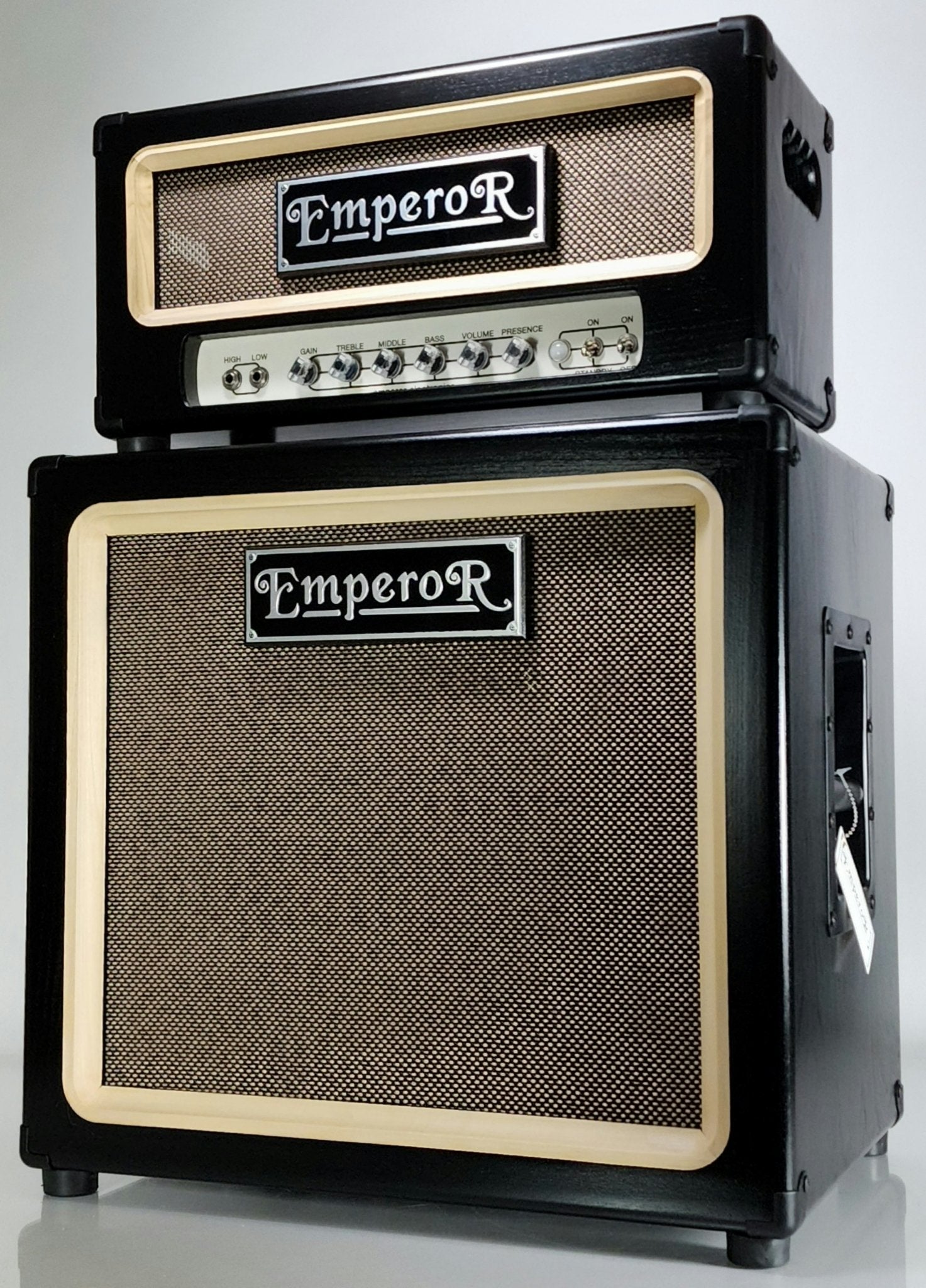 a black 100 watt guitar amplifier on top of a black 1x12 guitar speaker cabinet