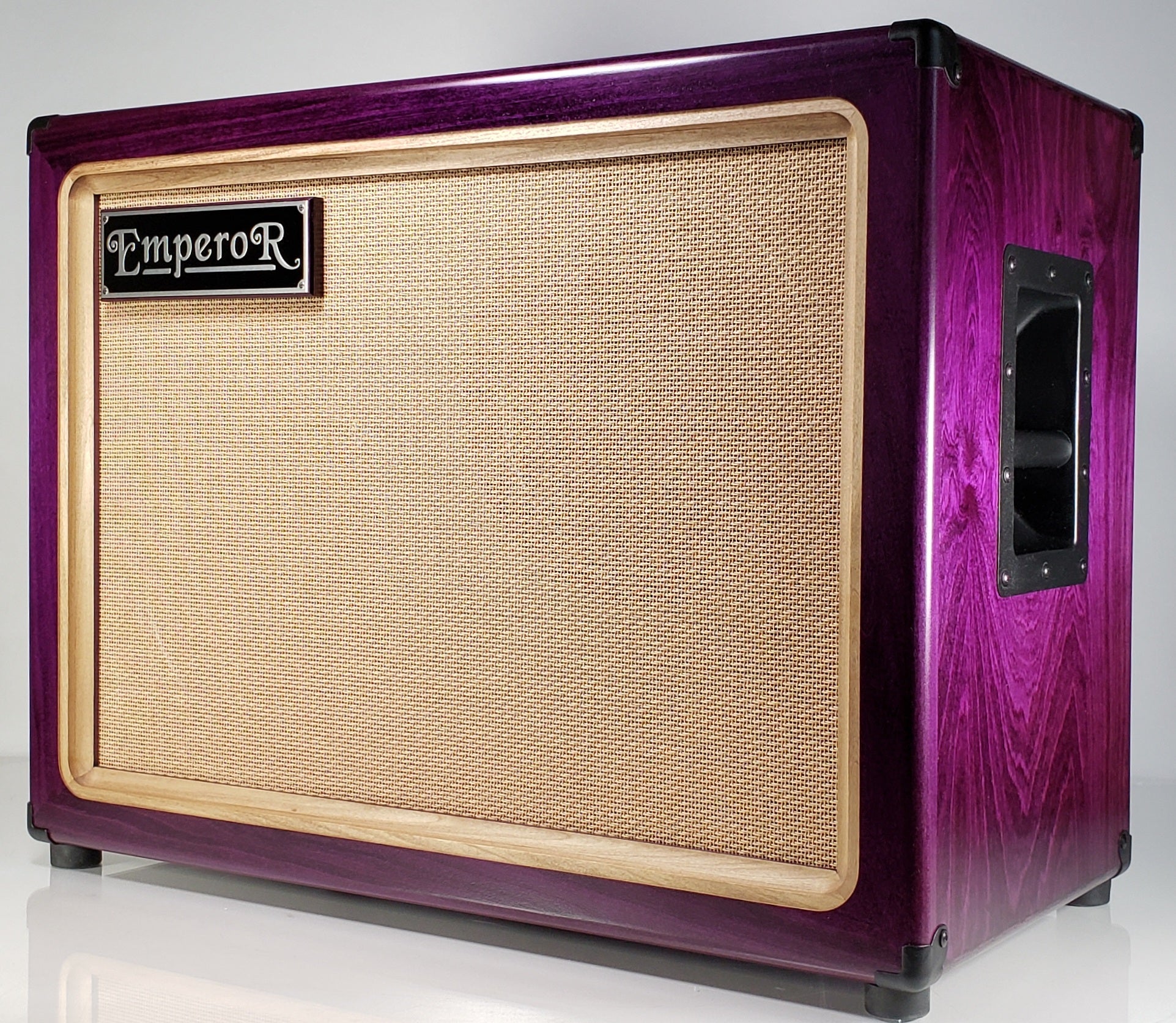 a purple 2x12 guitar speaker cabinet with a tan grille