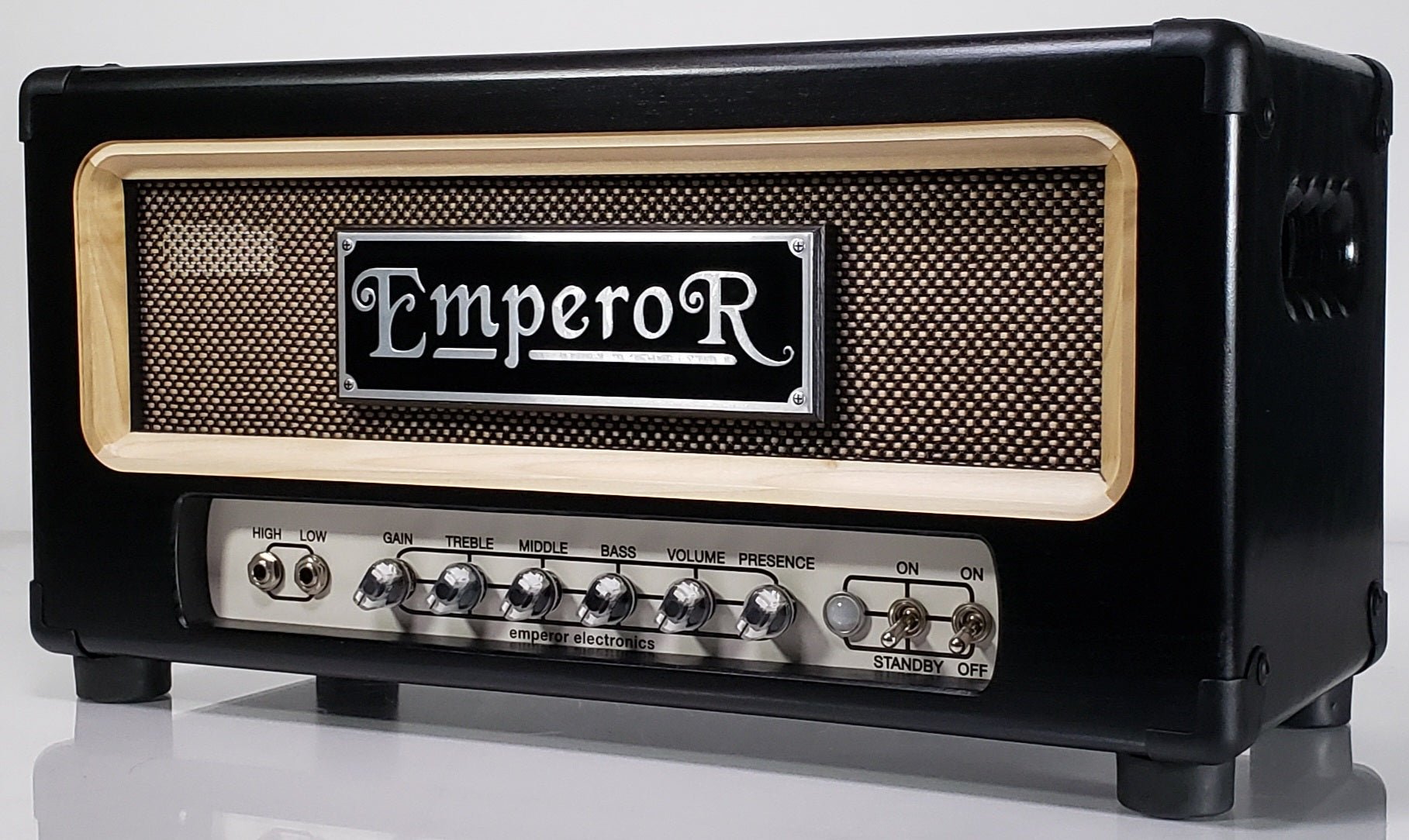 a black 100 watt guiar amplifier with a black and gold grille