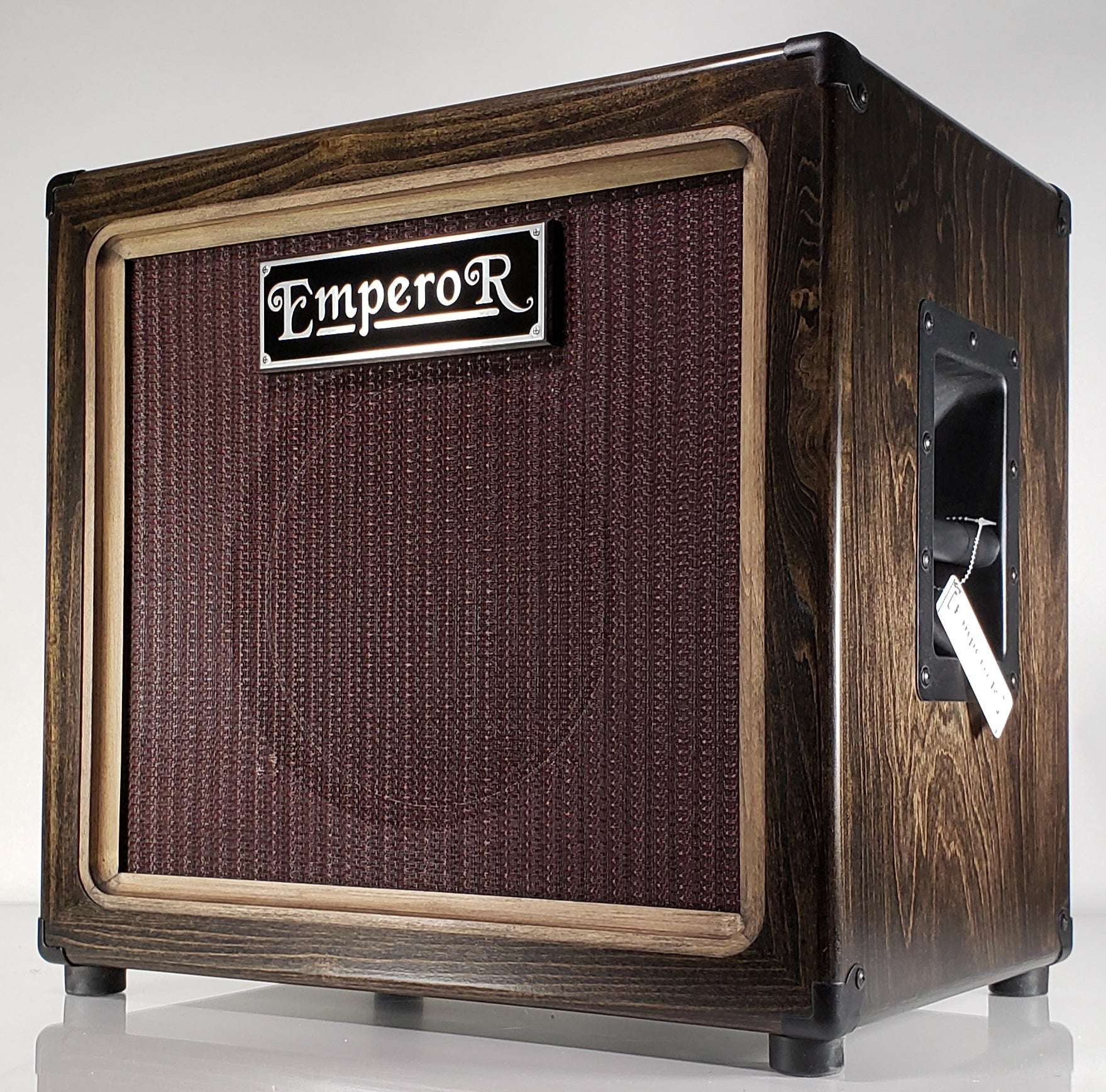 a 1x12 guitar speaker cabinet with a dark colored stain