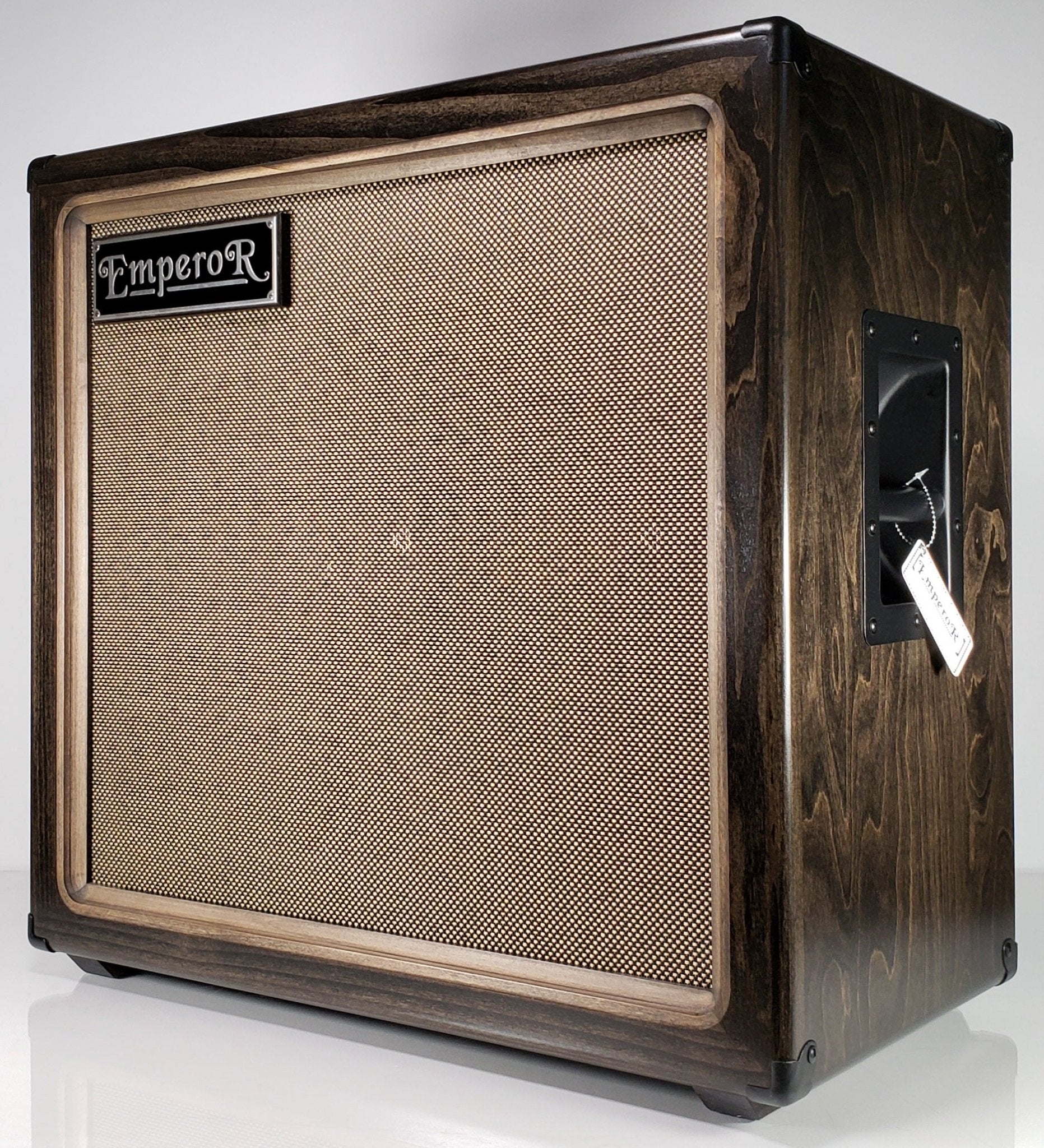 an oversized 2x12 guitar speaker cabinet with a black and gold grille