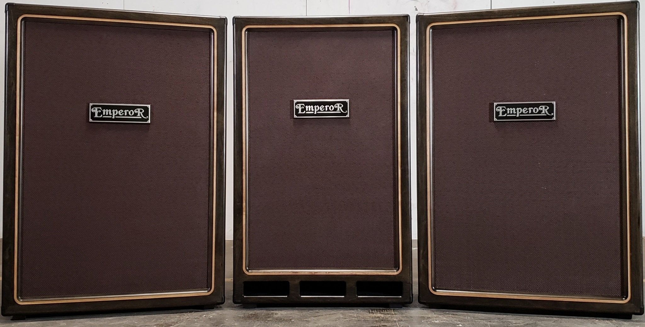 two 6x12 guitar speaker cabinets next to a 2x15 bass speaker cabinet